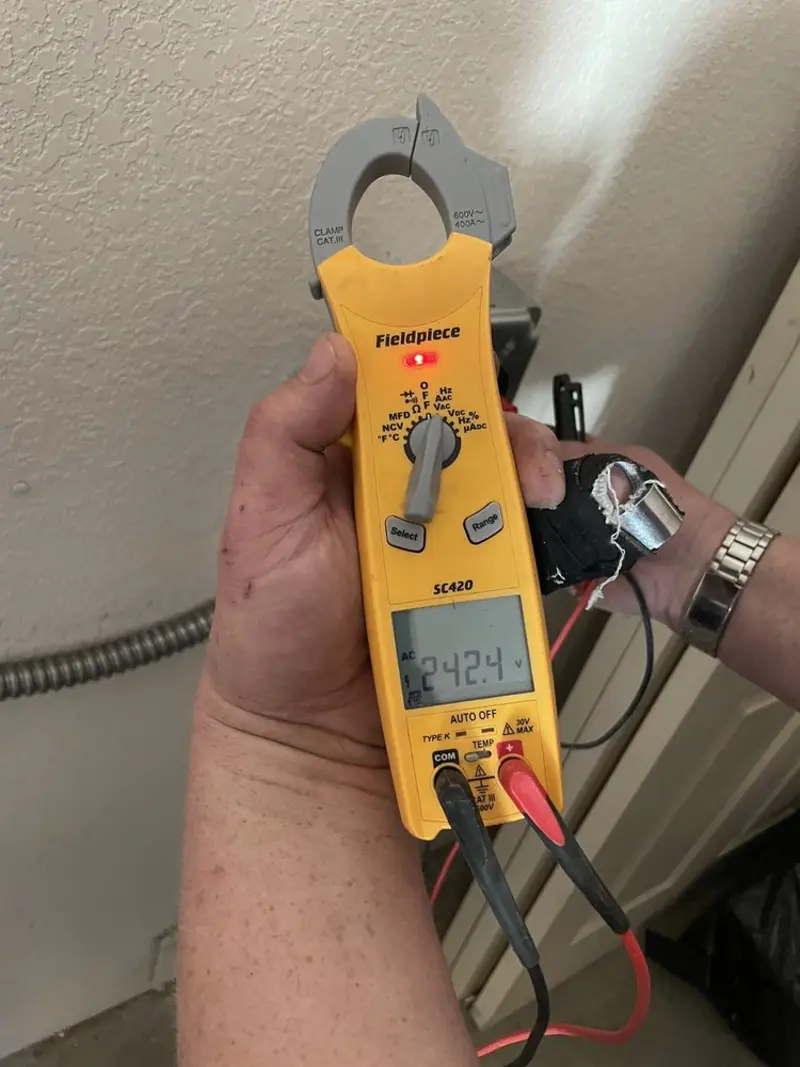 Voltage testing with clamp meter during Outlet Installation in Massena